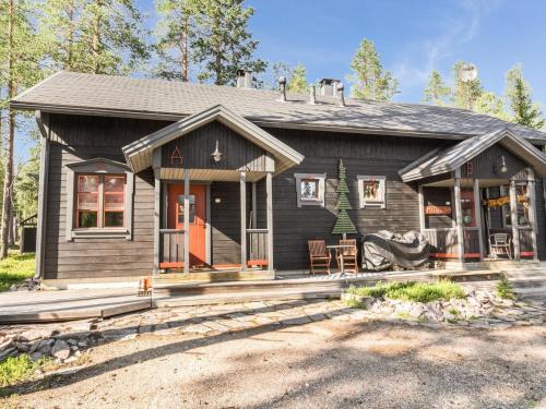 a black house with a porch and a porch at Holiday Home Alppitalo b by Interhome in Ylläsjärvi