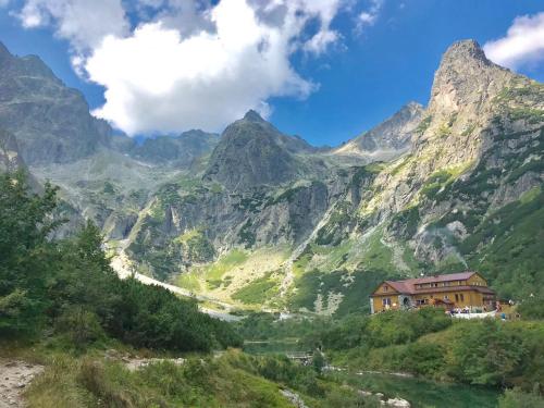 a mountain valley with a house and a river at Wellness Villa Totina in Liptovský Mikuláš – Demänová