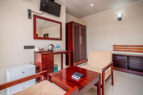 Habitación con mesa, silla y espejo. en Janora Hills en Kandy