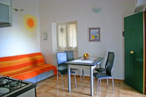 een keuken met een tafel en stoelen en een bank bij Casa il Gabbiano in Riomaggiore