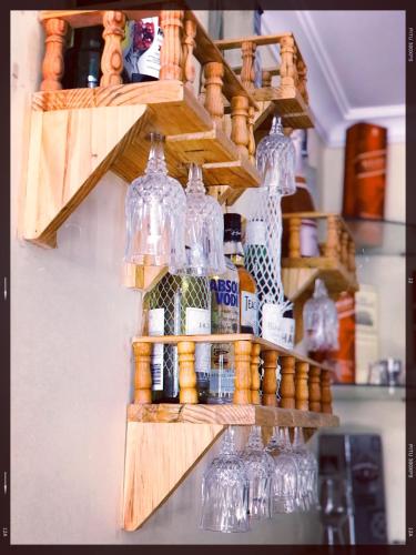 a bunch of bottles and glasses on a shelf at Hotel Tranquil in Kathmandu