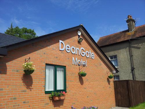 a sign on the side of a brick building at Deangate Motel in Lydney