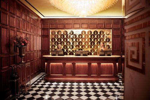 a bar in a room with a checkered floor at Bank Hotel, a Member of Small Luxury Hotels in Stockholm