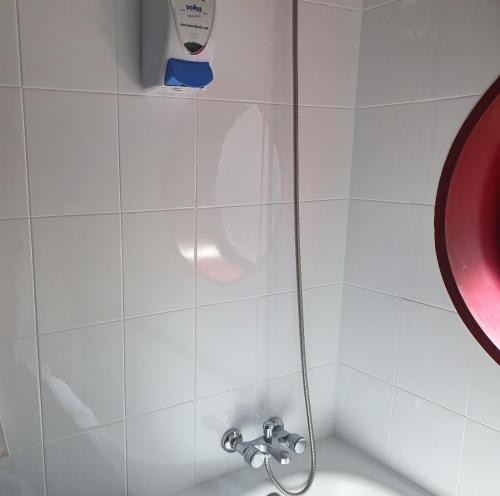 a shower with a shower head in a bathroom at Hotel City Express Comercio in Pontevedra