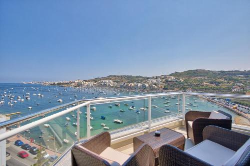 a view of a harbor with boats in the water at HV12 - Sea Front Penthouse in St. Paul's Bay