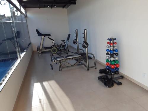 a gym with bikes and exercise equipment in a room at Revitalle Hotel in Votuporanga