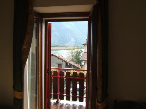 an open door to a balcony with a view at Hotel Berlinghera in Sorico