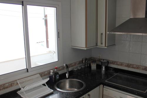 a kitchen with a sink and a window at Ayamonte Mirador in Ayamonte