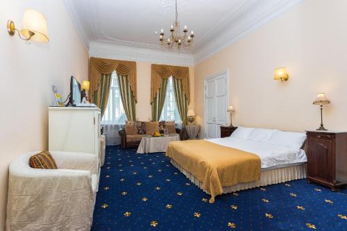 a hotel room with a bed and a couch at Casa Leto in Saint Petersburg