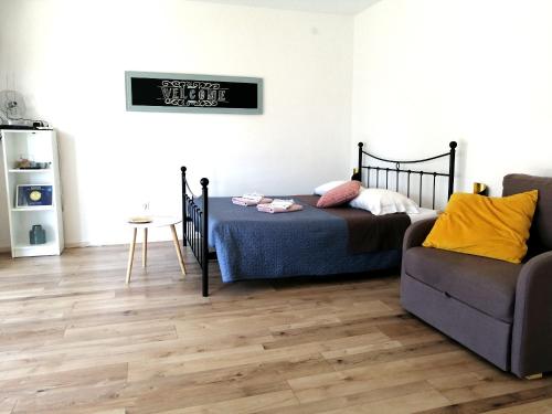a bedroom with a bed and a couch at Apartment Gabi in Umag