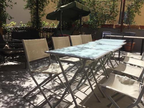 a table topped with a table cloth and chairs at New Hostel Florence in Florence