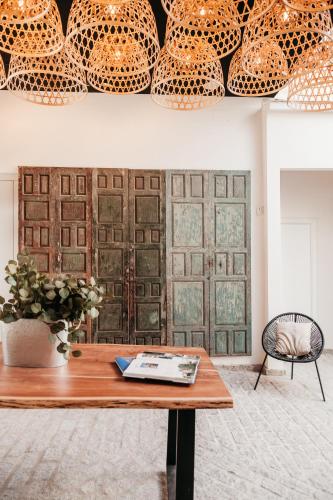 a room with a table and some vases on a wall at ASTUTO Boutique Jerez - Adults Only in Jerez de la Frontera