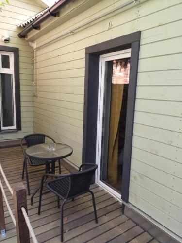 a patio with a table and chairs on a deck at Old Slabada Apartments in Kaunas