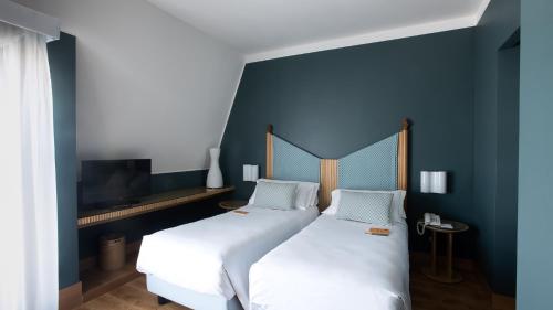 Postel nebo postele na pokoji v ubytování Hotel Spadari Al Duomo