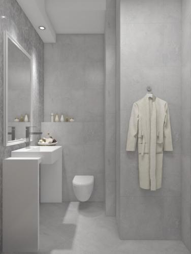 a bathroom with a white robe hanging on a wall at Twister Apartments in Budva