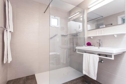 a bathroom with a shower and a sink at Aldiana Club Fuerteventura in Morro del Jable