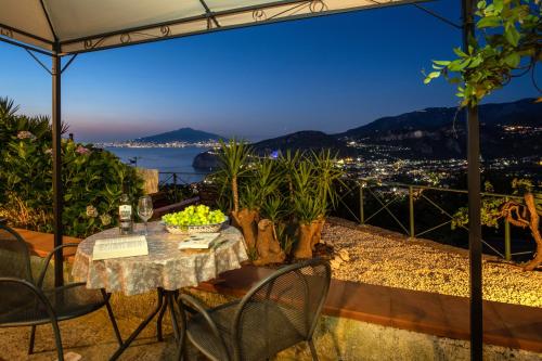 a table and chairs with a view of the city at Villa Monica B&B in Sorrento