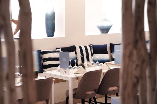 a dining room with a table and chairs and vases at Hotel Las Arenas in Can Pastilla