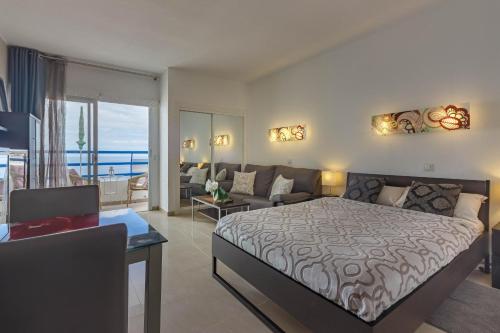 a bedroom with a bed and a living room at Adeje300, Playa Paraíso in Playa Paraiso