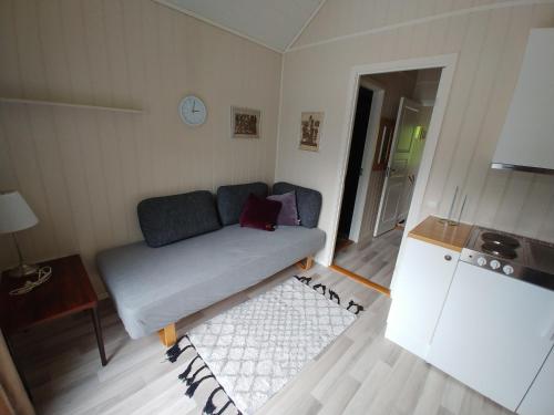 a small living room with a couch and a table at Nedre Amla Fjord Apartment in Kaupanger