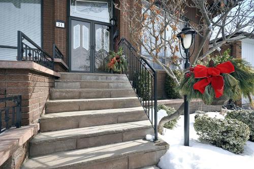 a house with a christmas wreath on the stairs at A Stunning Chalet Style Home in Toronto