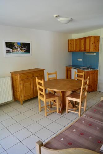 a kitchen with a wooden table and chairs at CIS-Ethic Etapes de Val Cenis in Lanslebourg-Mont-Cenis