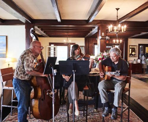 a group of people playing music in a room at Black Point Inn in Scarborough