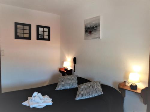 a room with two beds and two lights on the wall at Hôtel Restaurant de l'Abbaye in Clairvaux