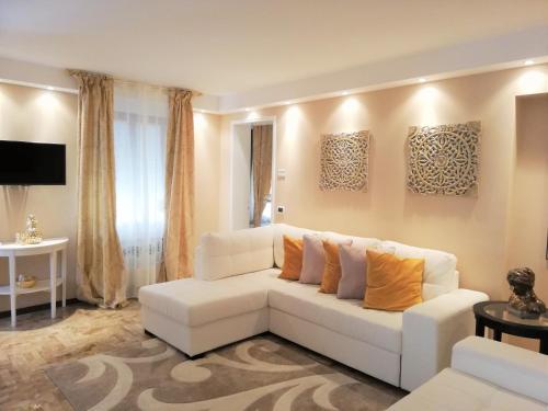 sala de estar con sofá blanco y almohadas de color naranja en SAN MARCO3 Apartment, en Venecia
