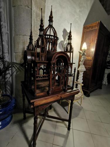 a bird cage sitting on top of a table at Château de Verdalle in Verdalle
