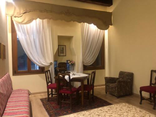 a dining room with a table and chairs and a couch at La Capannaccia - Venice in Venice