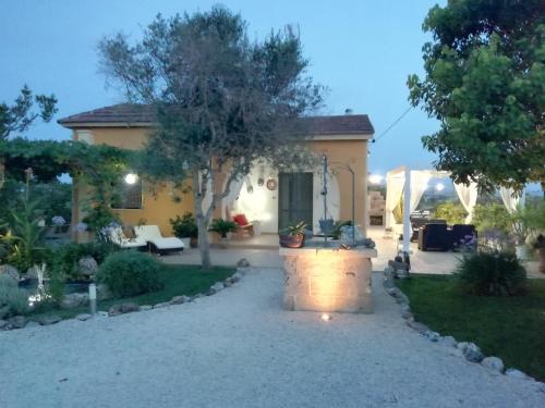 a house with a patio and a yard at Villetta Dote in Casarano