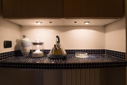 a kitchen counter with a tea kettle and a blender at Santa Chiara Grand Suite by Wonderful Italy in Naples