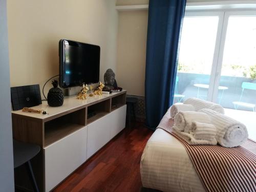 a bedroom with a bed and a television on a dresser at Lx Art Flats | Flat Two in Lisbon