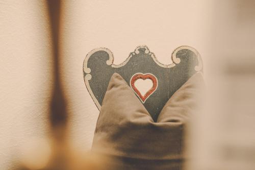 a hand holding a heart on a wall at Der Lederer Hof - Boutique Apartments in Tegernsee