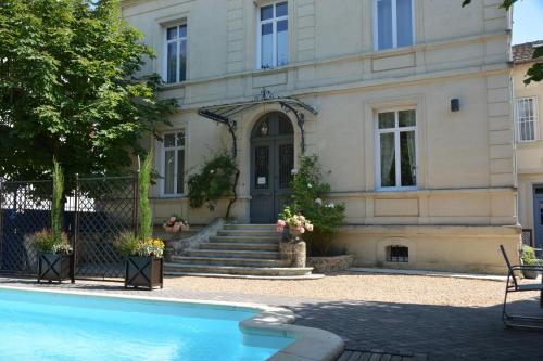a house with a swimming pool in front of it at Villa Vesone in Périgueux