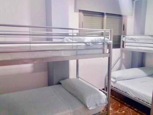 Postel nebo postele na pokoji v ubytování Casa Playa Gandia Centro II