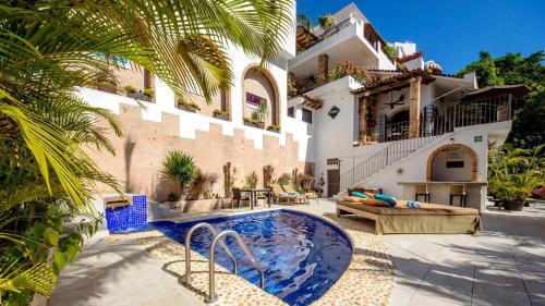 a house with a swimming pool next to a building at Casa Cupula LGBT Luxury Resort in Puerto Vallarta