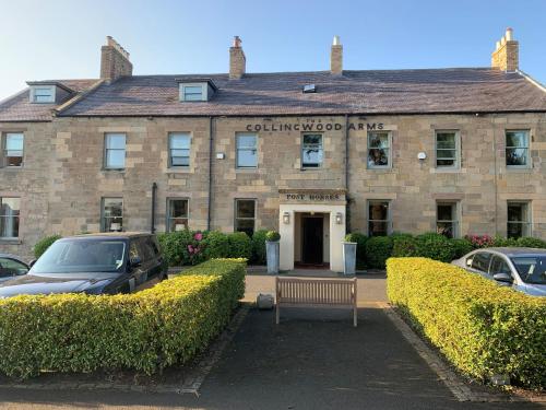 a building with a bench in front of it at Collingwood Arms Hotel in Cornhill-on-tweed