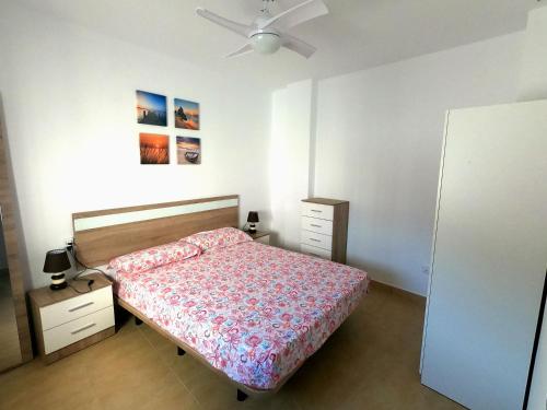 a bedroom with a bed and a ceiling fan at Casa Martina in Vejer de la Frontera