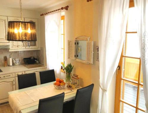 a kitchen with a table with chairs and a dining room at Apartment Marjetica in Moravske Toplice