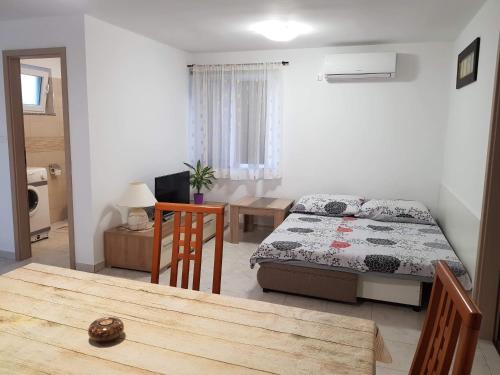 a living room with a bed and a dining room table at Apartment Natali in Brseč
