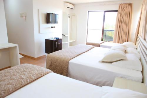 En eller flere senger på et rom på Hotel Ares do Sertão
