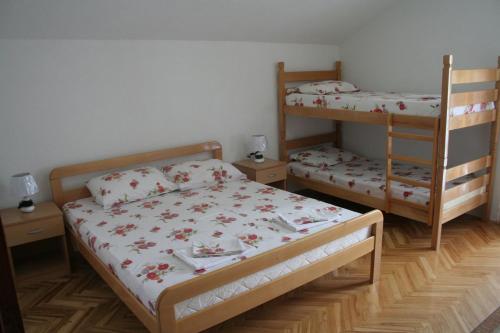 a bedroom with two bunk beds and a ladder at Villa Karolina in Ohrid