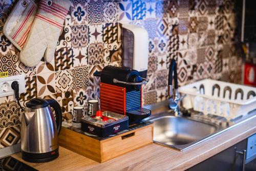 a kitchen counter with a mixer and a sink at Arca Sweet Apartment in Gura Humorului