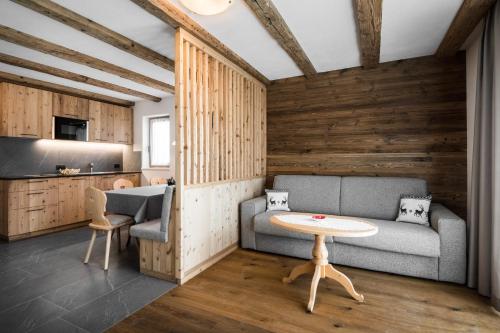 a living room with a couch and a table at Chalet Dolomit in San Lorenzo di Sebato