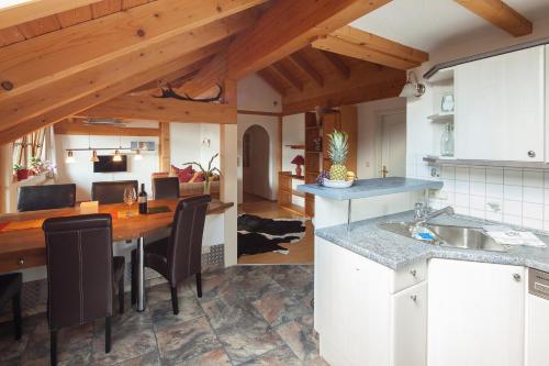 a kitchen and living room with a table and chairs at Ferienwohnungen Weidach in Oberstdorf