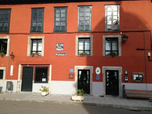 a orange building with two doors and a bench at La casina del Indiano in Malleza