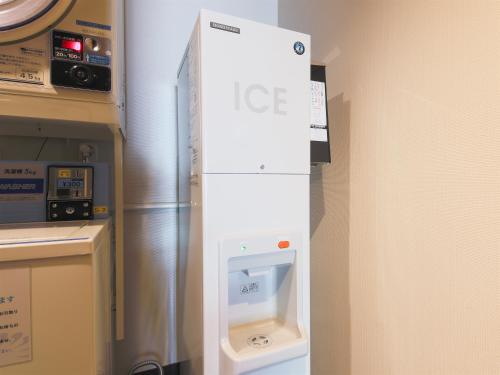 a refrigerator with an ice dispenser in a room at APA Hotel Yamagata Tsuruoka Ekimae in Tsuruoka