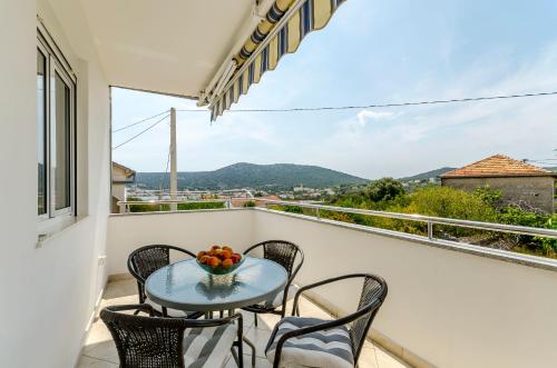 a table and chairs on a balcony with a view at House Ivana in Vinišće